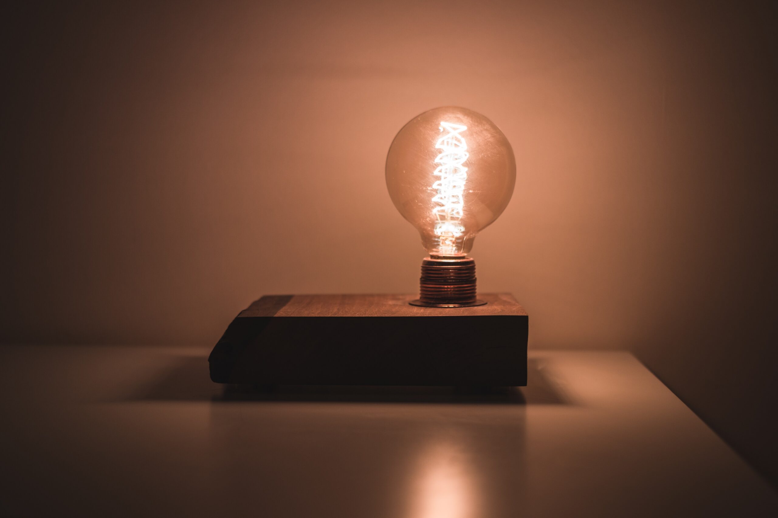 lightbulb on a table in a dim lit room