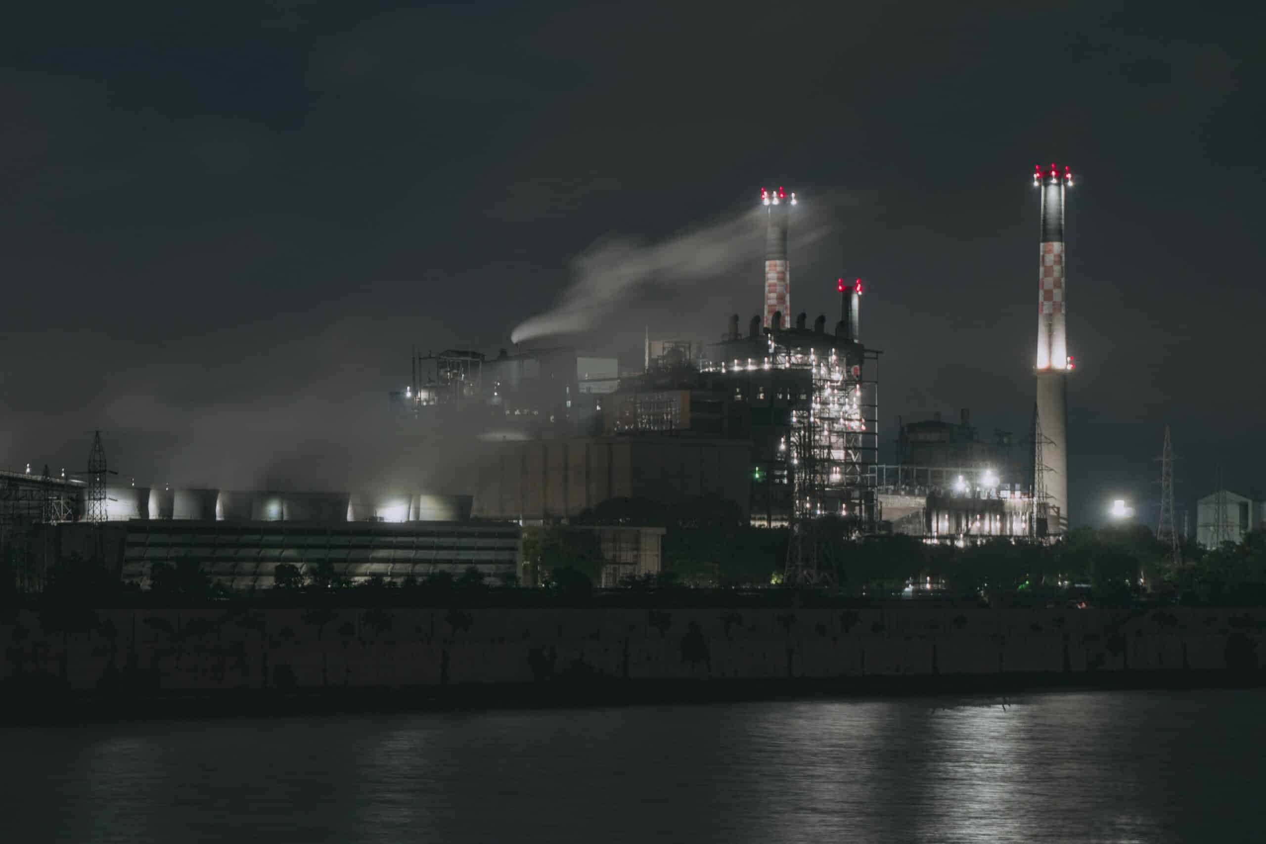 manufacturing building on a foggy night along the water